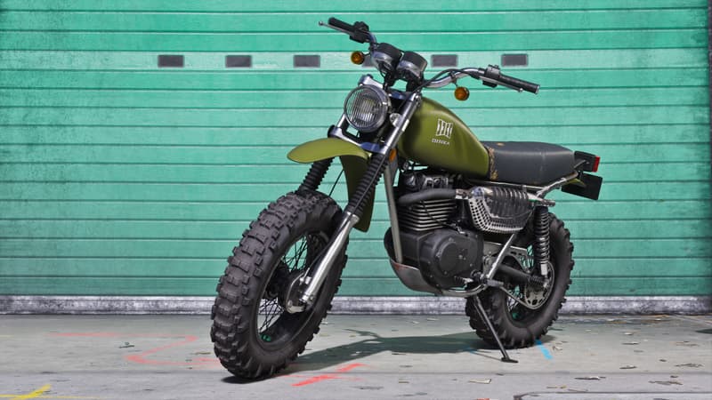 An olive green Dinka dirt bike on knobbly tyres stands on its kickstand against a teal roller shutter.