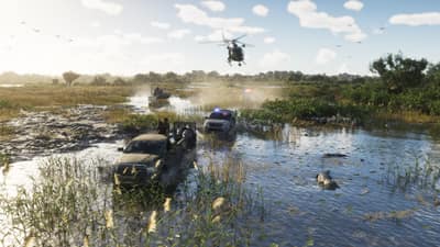 A pickup and a police SUV throw spray crossing flooded marshland, helicopter overhead.