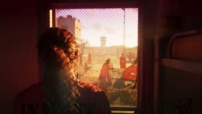 Lucia in an orange INMATE shirt at a barred window overlooking the prison yard