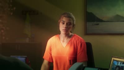 Lucia seated in the prison counsellor’s office, orange inmate shirt, family photos behind