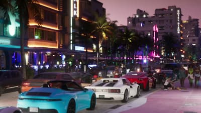 Neon-lit strip of art deco hotels with sports cars nosed in at the kerb