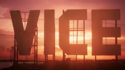 Enormous VICE billboard letters silhouetted against a burning orange sunset