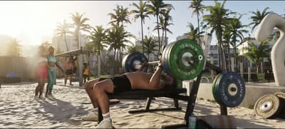 Bench pressing at an outdoor beach gym under palms in hazy golden-hour light