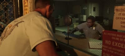 Prison visitation desk, a guard behind the glass beneath red warning signage