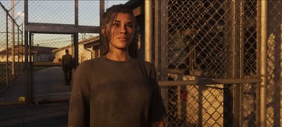 Lucia walking out through the prison gate at sunset in plain release clothes