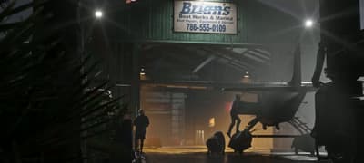 Brian’s Boat Works and Marina at night, hulls up on stands under floodlights