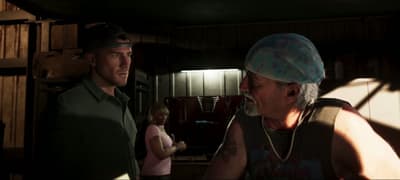 Jason talking with a grey-goateed man in a paisley bandana cap inside a dim club