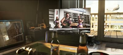 The Phil’s Ammunation advert playing on a living-room TV beside a games console