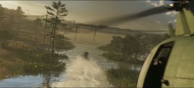 Airboat racing down a wetland channel as a helicopter banks in low behind it