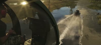 From the pursuing airboat, spray fanning out across a sunlit marsh channel