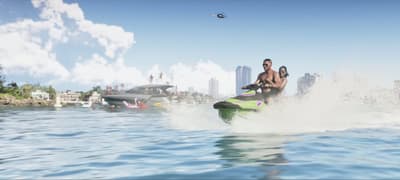 Two riders on a green jet ski cutting across the bay toward the city skyline