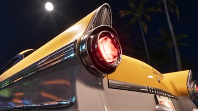 A yellow fifties sedan's tail fin and round red light under a full moon and palms.