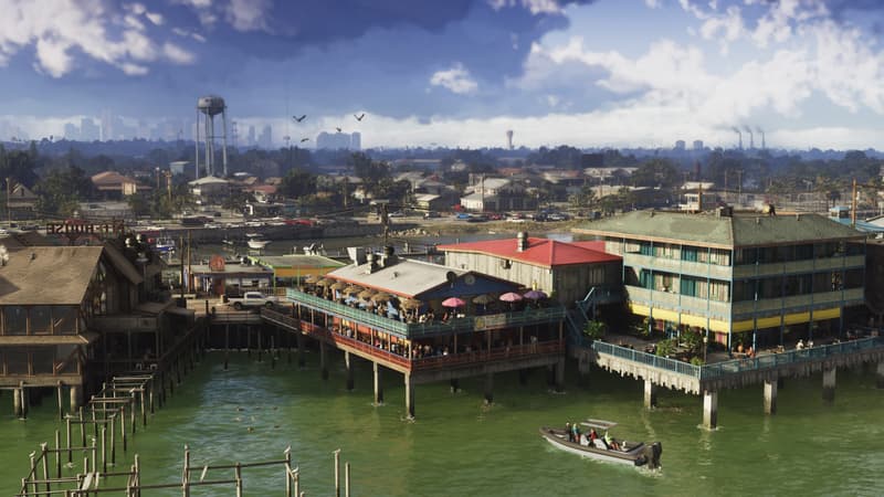 Painted bars and houses stand on stilts above green water, a small boat passing a low marsh town.