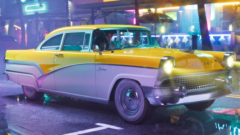A two-tone fifties sedan with chrome grille and whitewall tyres on a wet neon-lit street at night.